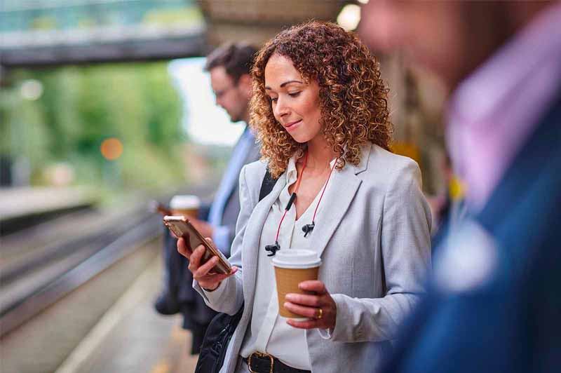 Woman on phone waiting for a train 