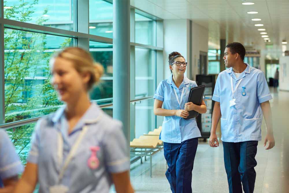 Clinicians walking in hospital Clinicians walking in hospital